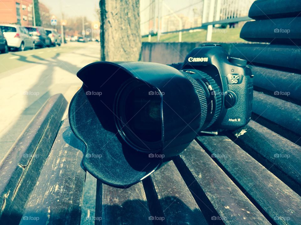 Professional photo camera on a seat