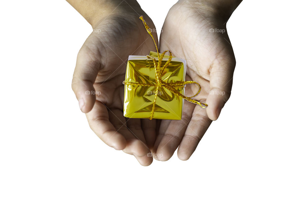 Isolated Hand holding Gift box gold for the festivities on a white background.