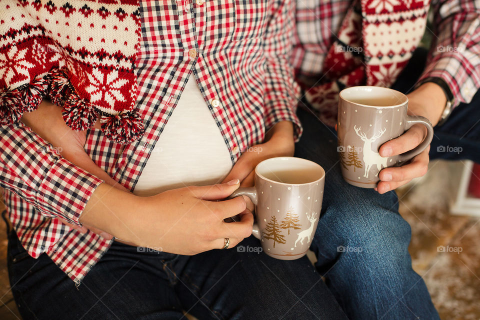 Couple holding coffee cup