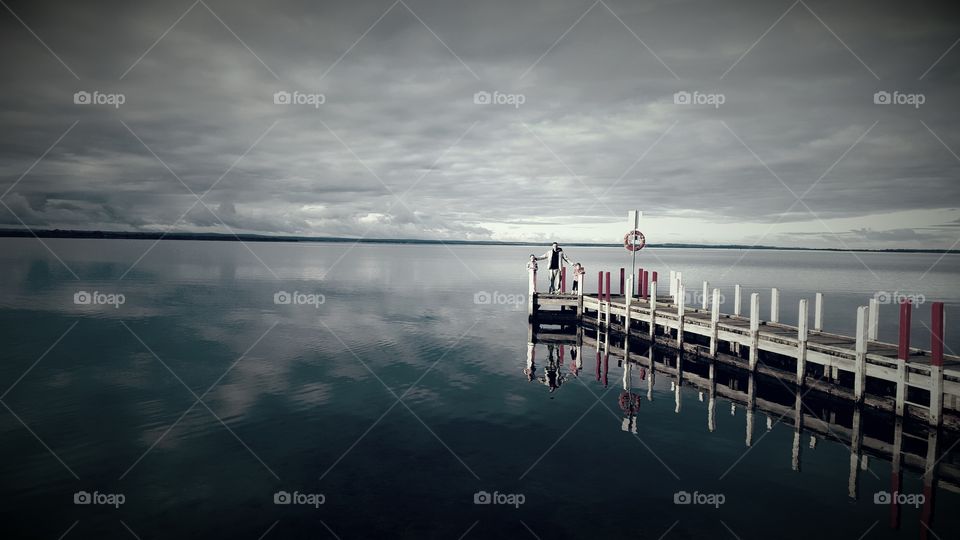 Serenity.... so peaceful, calm and quiet. Taken of a jetty on Lake King in Eagle Point Victoria, Australia. The photo was taken in July 2015, during Winter. It has been edited with a blue filter which has enhanced the colouring and cloud formations.