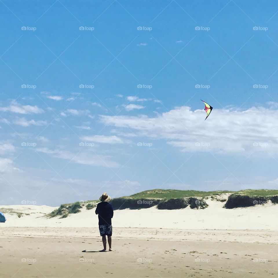 Flying a kite at the beach