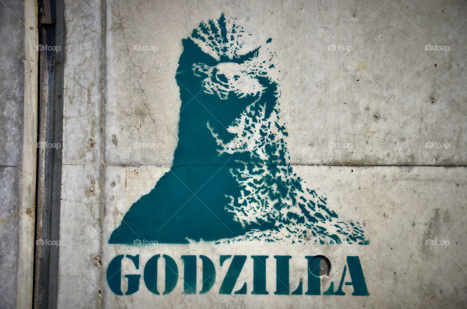 blue green street art godzilla by hugo