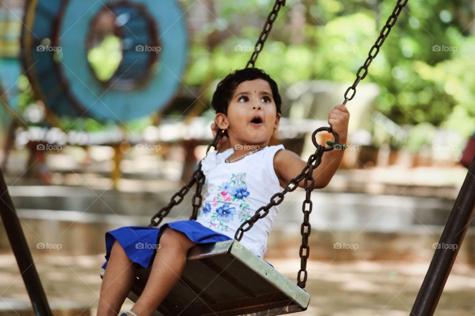 Happy and smiling Indian child playing in a park