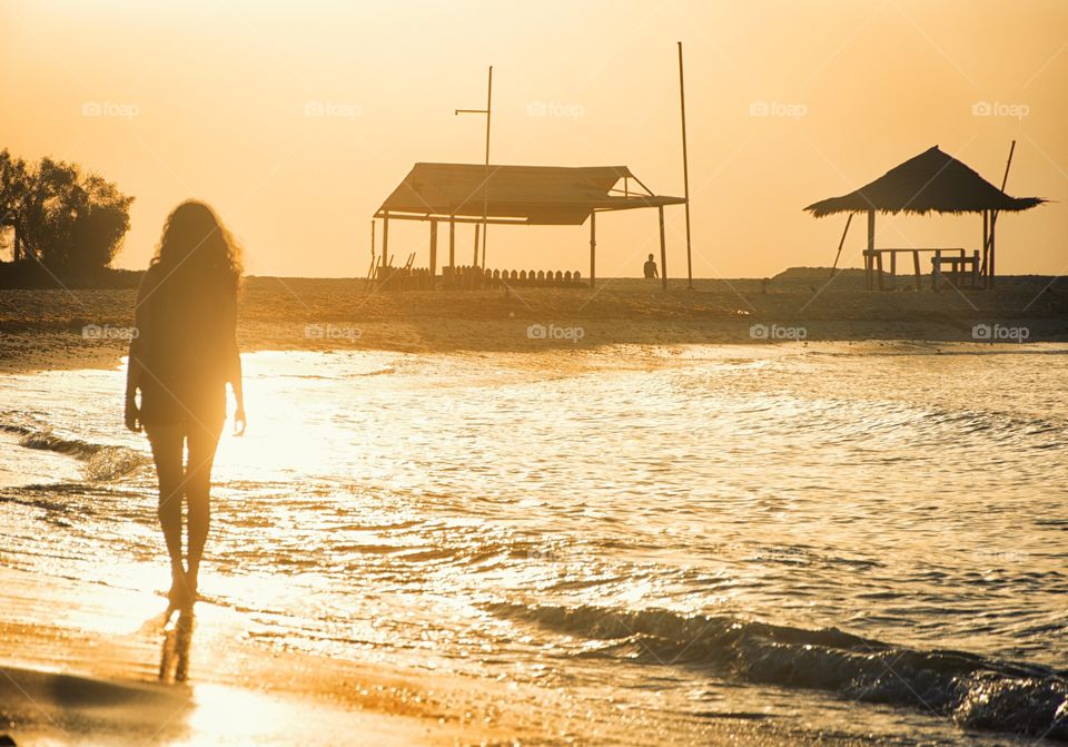 walking by the beach at sunset