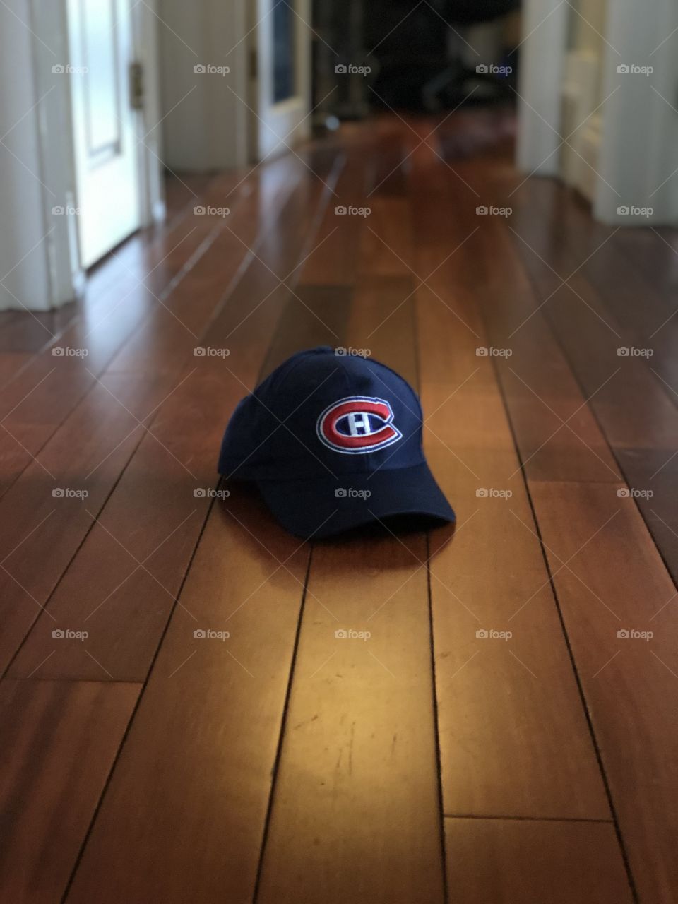Montreal Canadiens hat on display in oddly hallway on wood floor