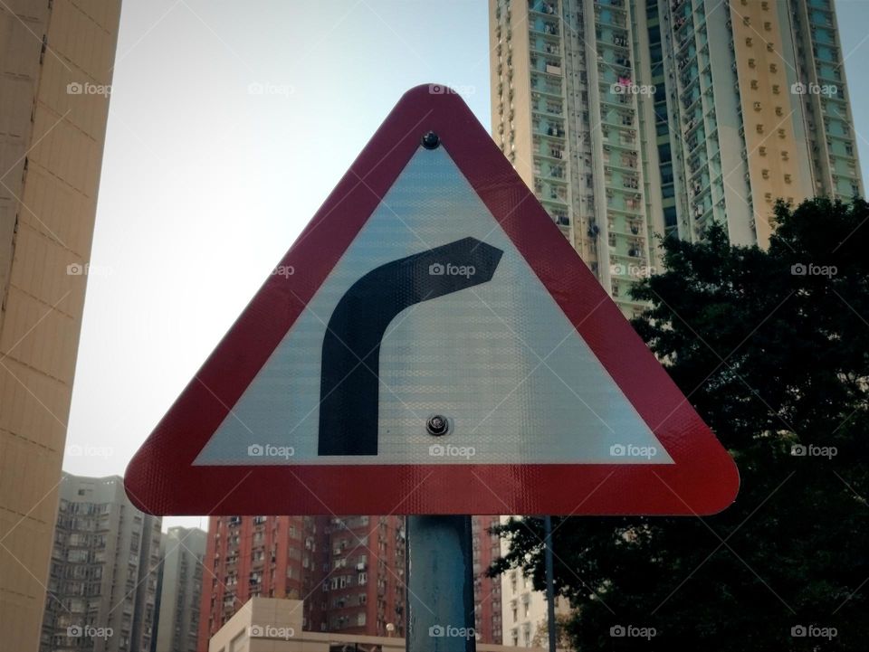 Note: There is a curved road ahead. (triangular road sign)