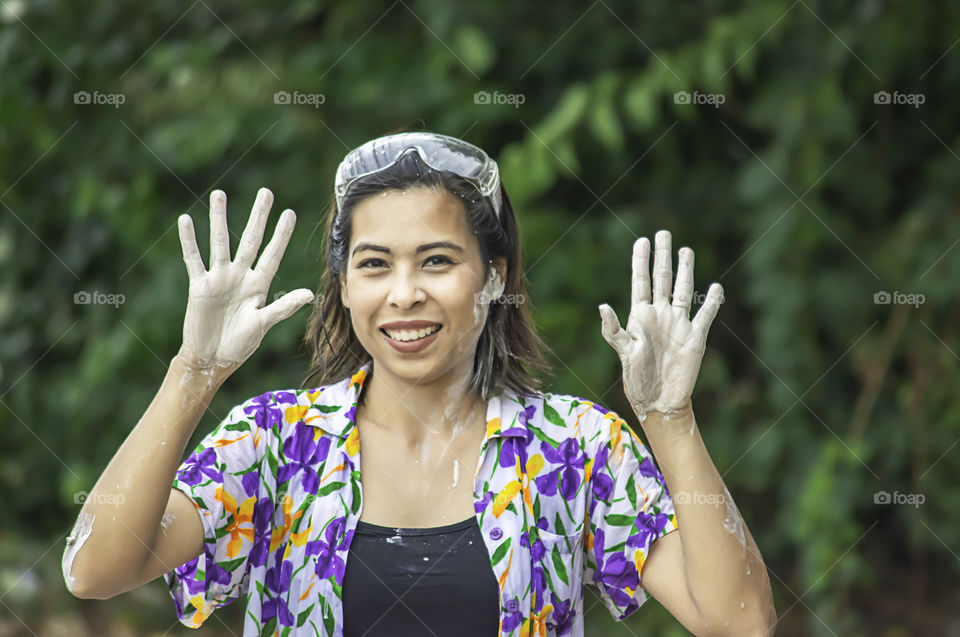 Asian woman play water and flour in Songkran festival or Thai new year in Thailand.