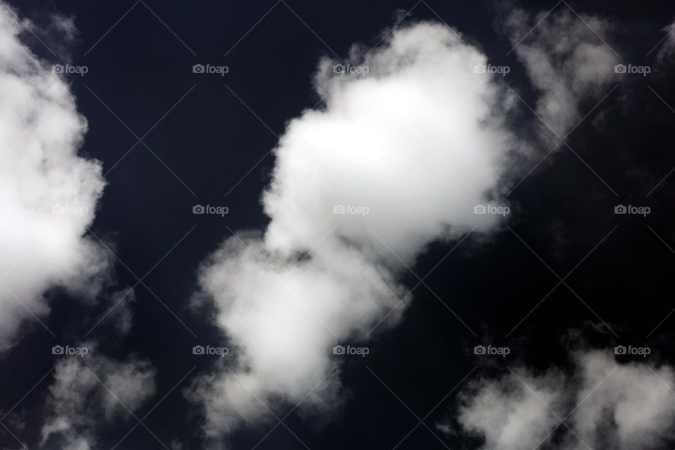 Black sky with clouds trippy psychedelic minimalistic background winter season daydreaming