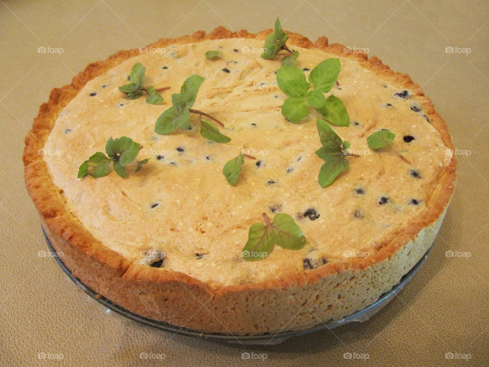 Pie with fresh blueberries and green basil