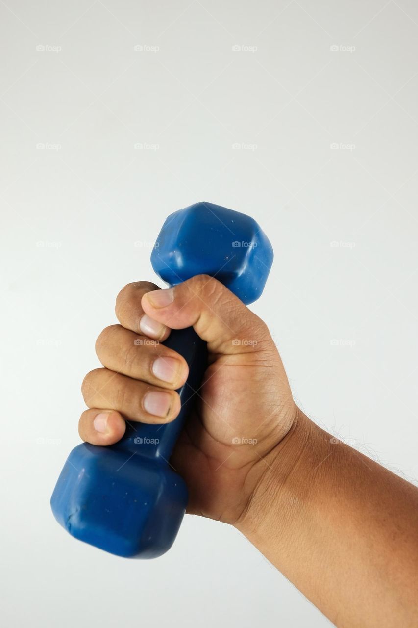 Dumbbell in hand. Gymnastics equipment. Exercises to exercise the arm