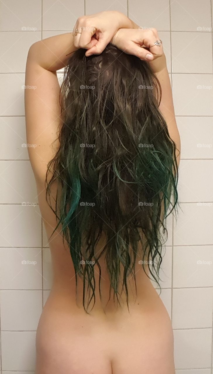 nude white girl with long green and black hair in shower