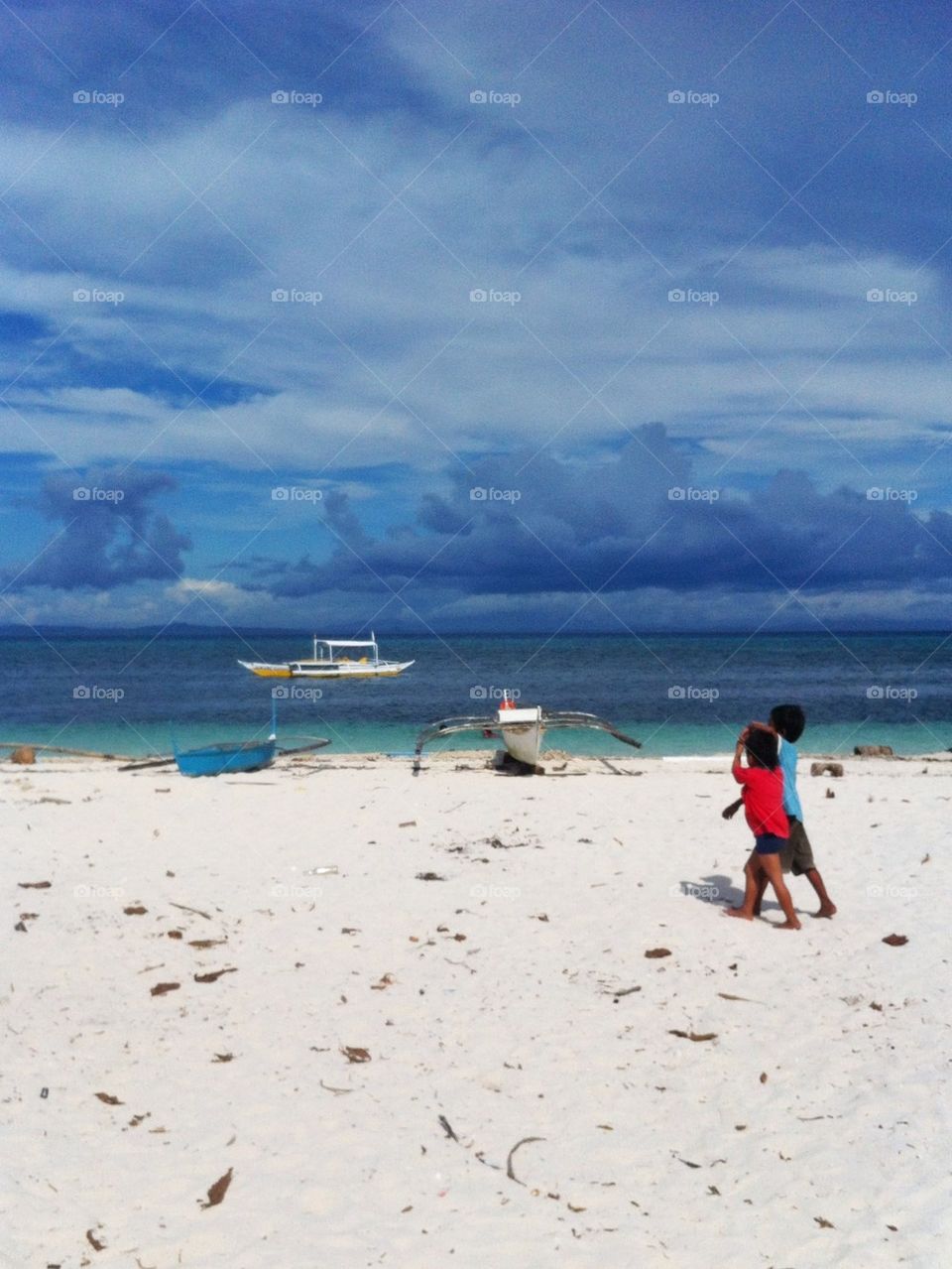 Kids walking on the beach