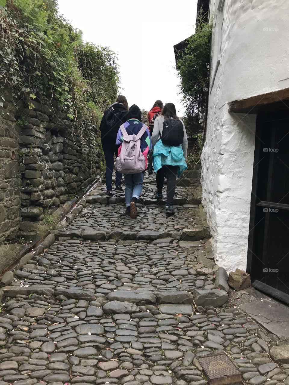 Young visitors to this beautiful place that is Clovelly, where you get one half a mile of these cobbled stones.