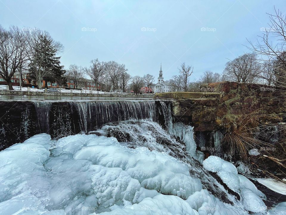 Partially frozen waterfall in a New England town.. 