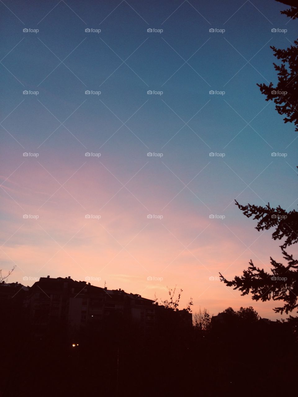 The sky is coloured with your favorite shades of blue and sunset orange. The view from the balcony.