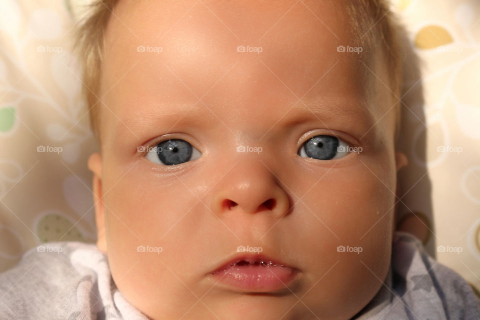 Close up of a blue eyed baby boy 
