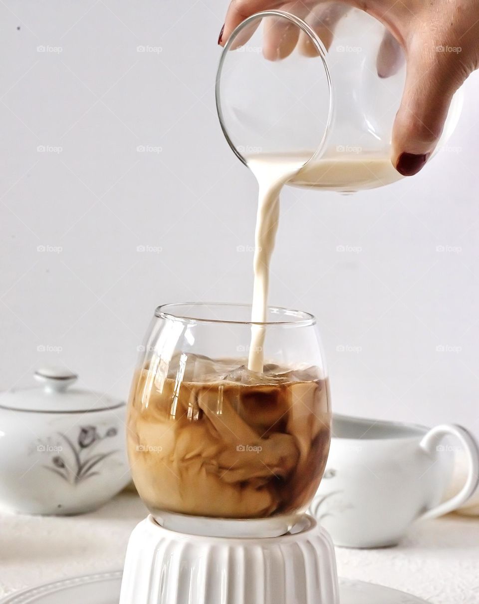 Milk pouring in coffees