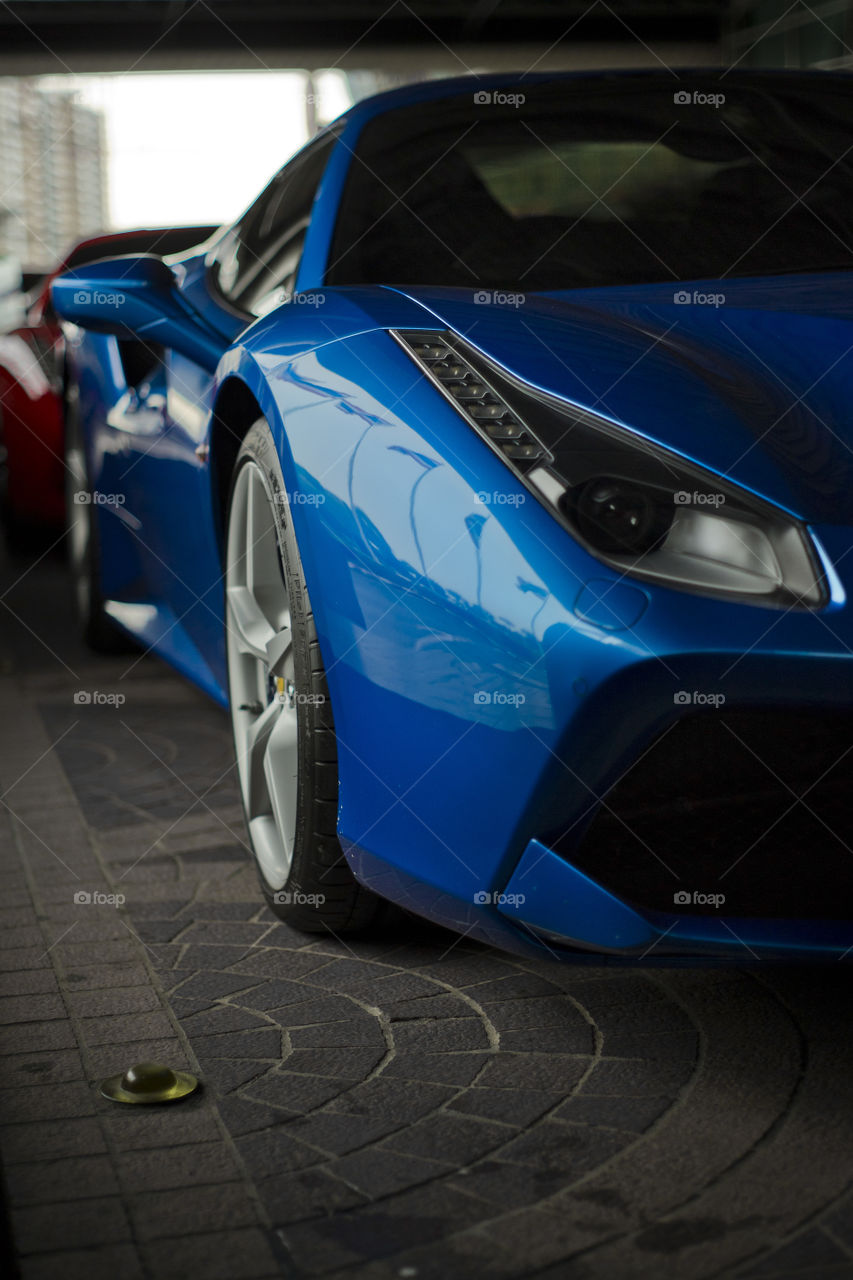 Blue Ferrari 488 spider coupe sports car 3.9 liter V8 twin turbo charged  (F154CB V8) close up front side view