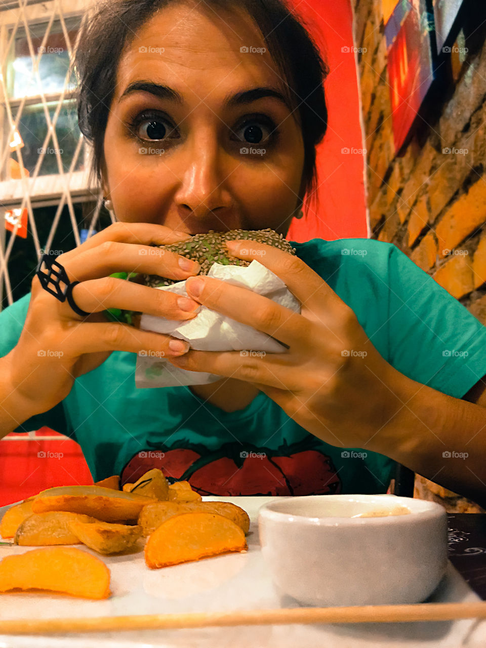 Young girl eating a burger