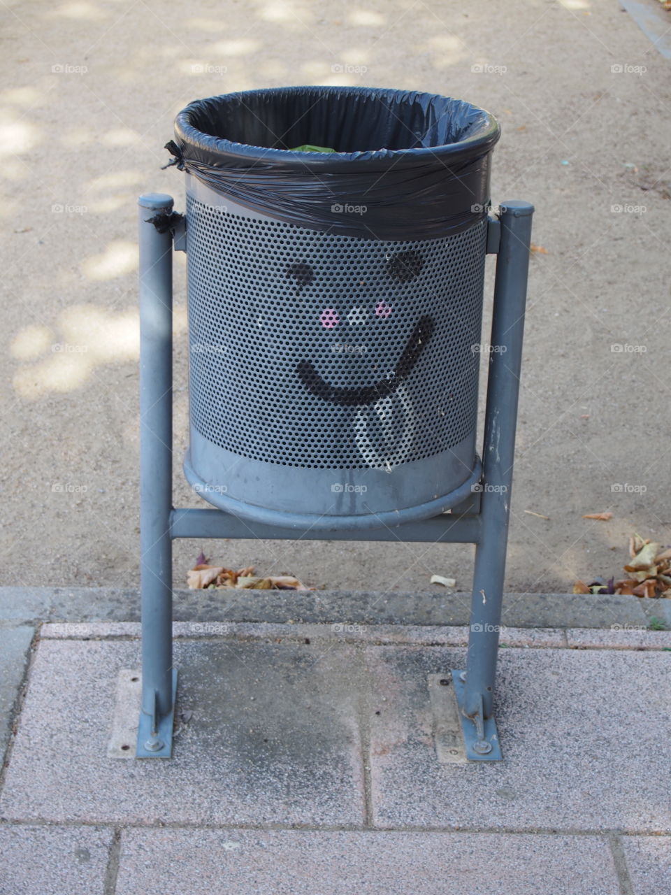 Trash bin on sidewalk