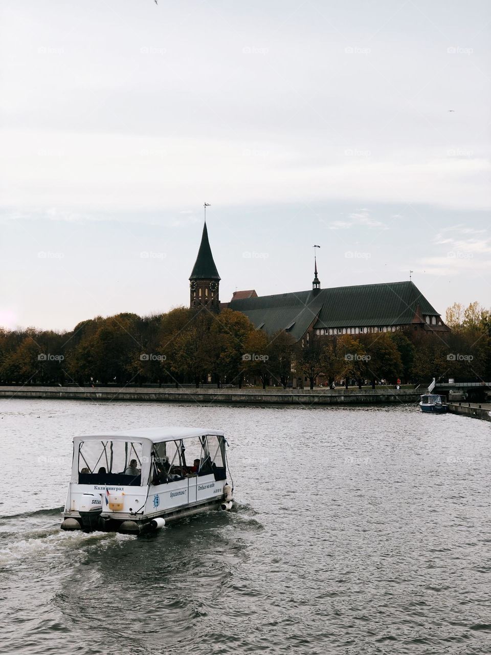 Boat on river in old historical city in autumn day, Kaliningrad, Russia 