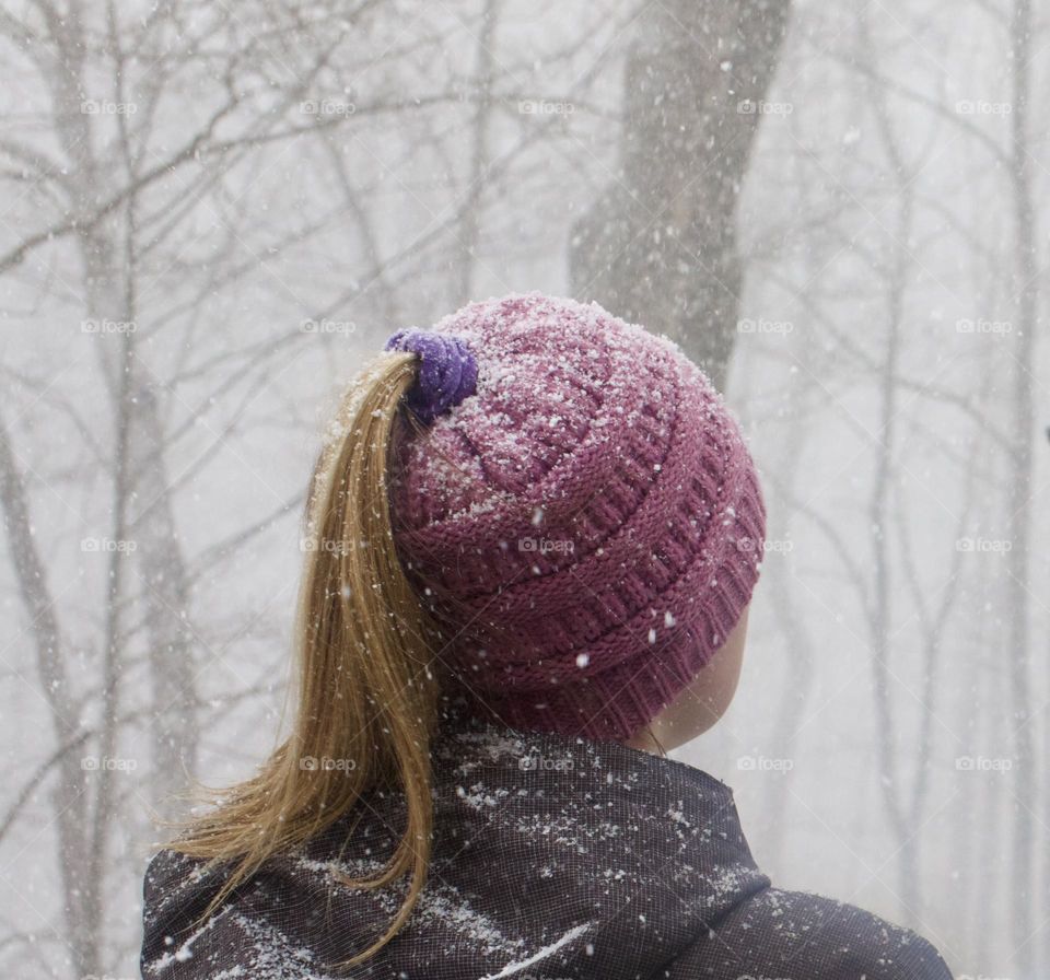Magenta; Woman outdoors in snow squall with beanie adding a pop of color