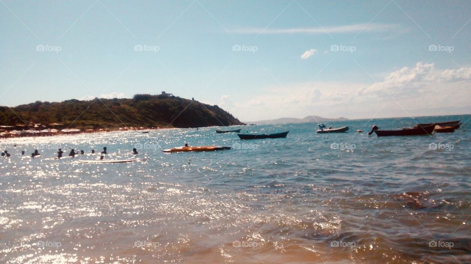 Boats and people. Tartaruga beach, Buzios. R,J. Brazil.