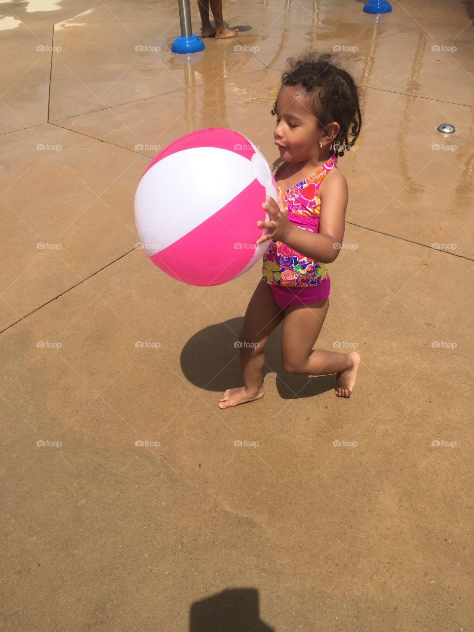 Splash pad time with beach ball 
