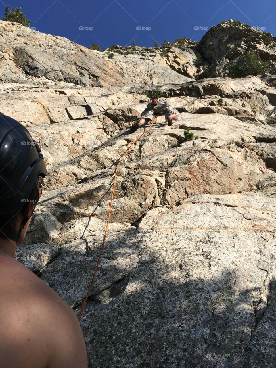 Rock climber climbing up a rock