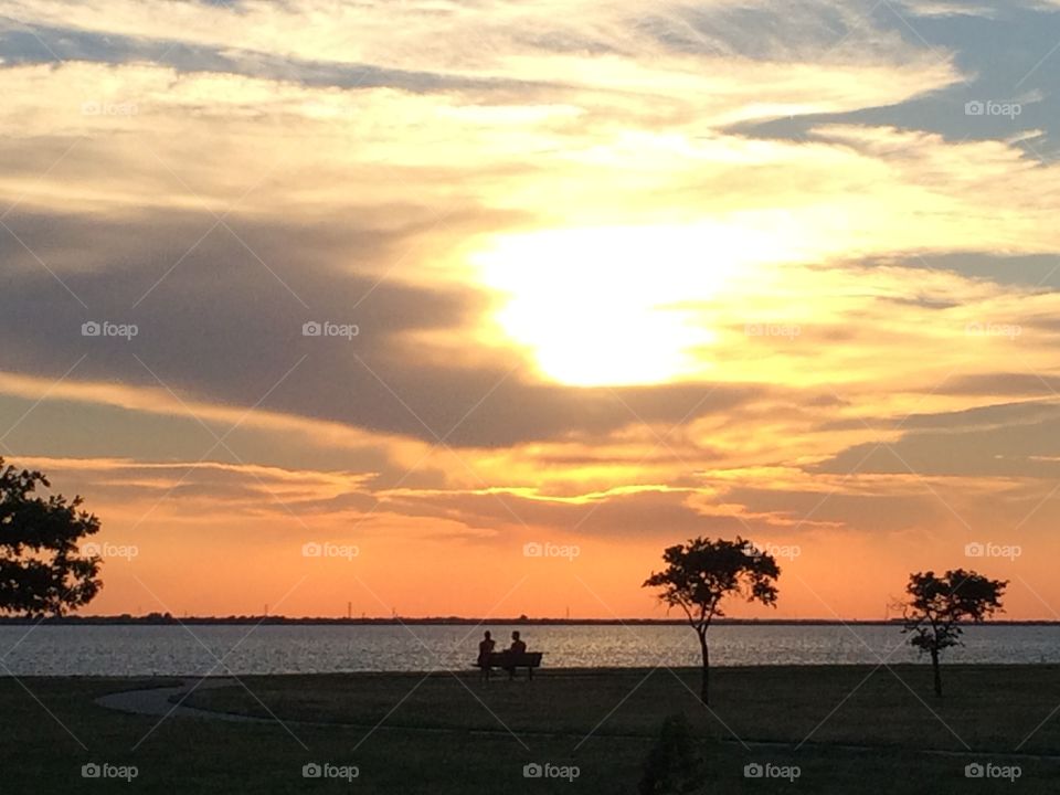 Sunset over the lake at dusk. Watching the sun set from the park overlooking Lake Hefner in OKC. 