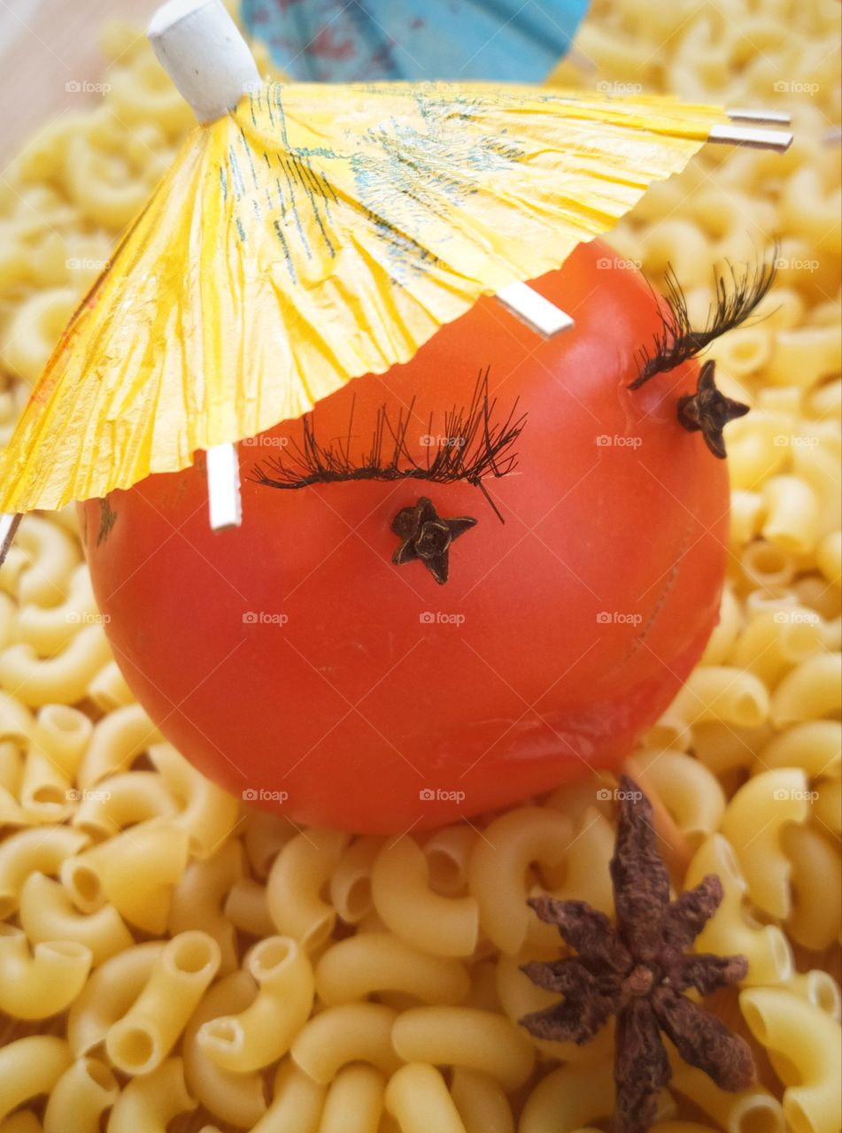 Tomato with eyelashes on pasta snails
