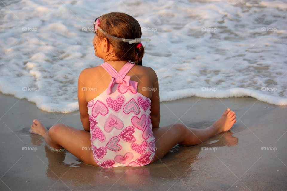 Girl sitting in ocean