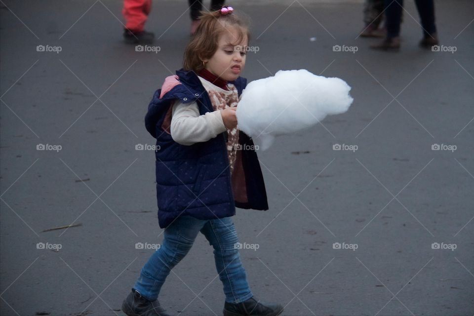 Cute girl with candy floss at beach