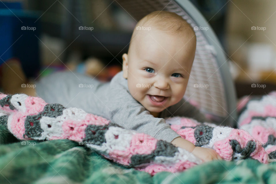 Happy baby boy laughing on belly 