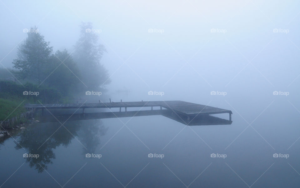 foggy morning at the lake in polish countryside