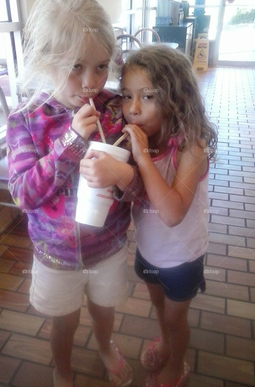 my girls sharing a soda....