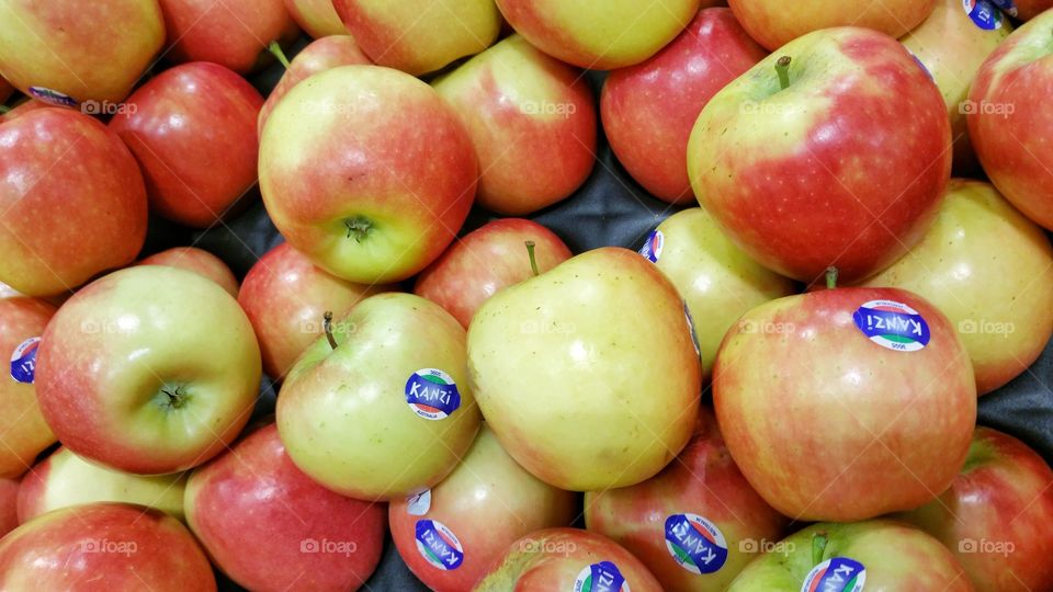 Fresh Kanzi branded apples on display at a local market.