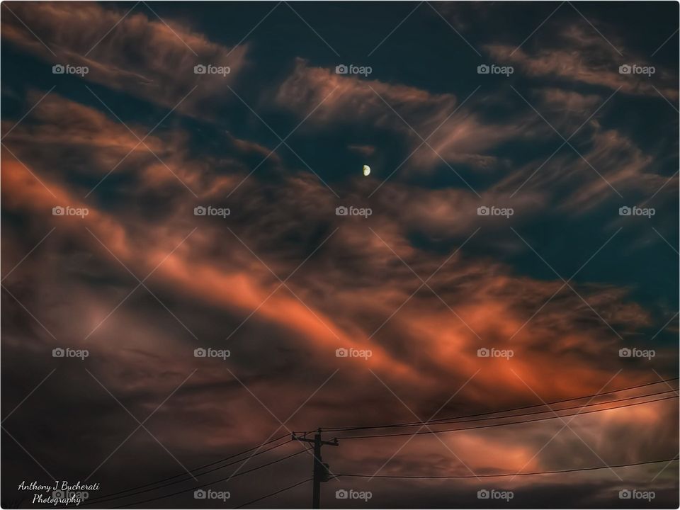 A burning sky with a half Moon