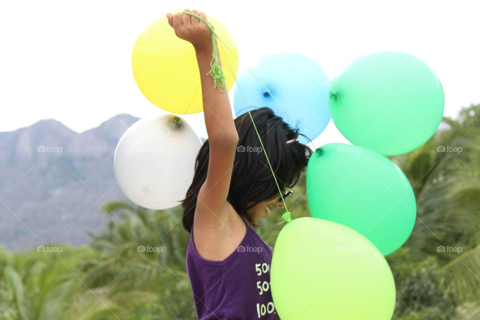 kid with balloons