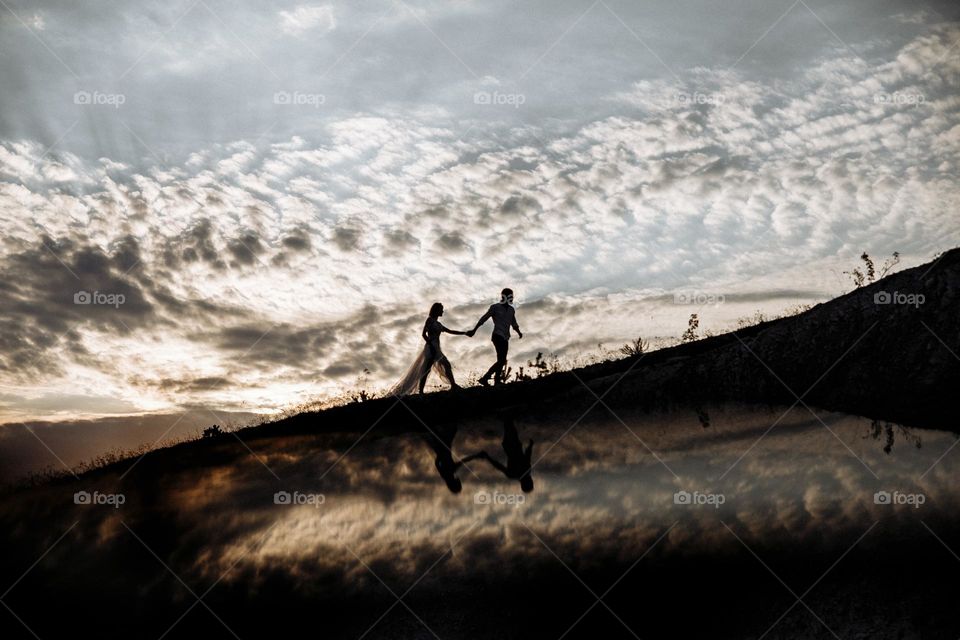 Couple in love walking on sunset