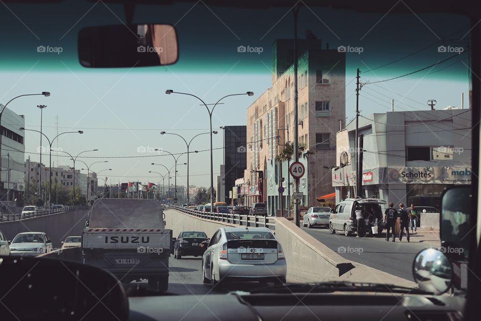 Driving in a car through a busy city