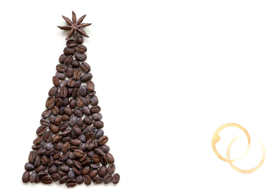 Christmas tree made of coffee beans on white background