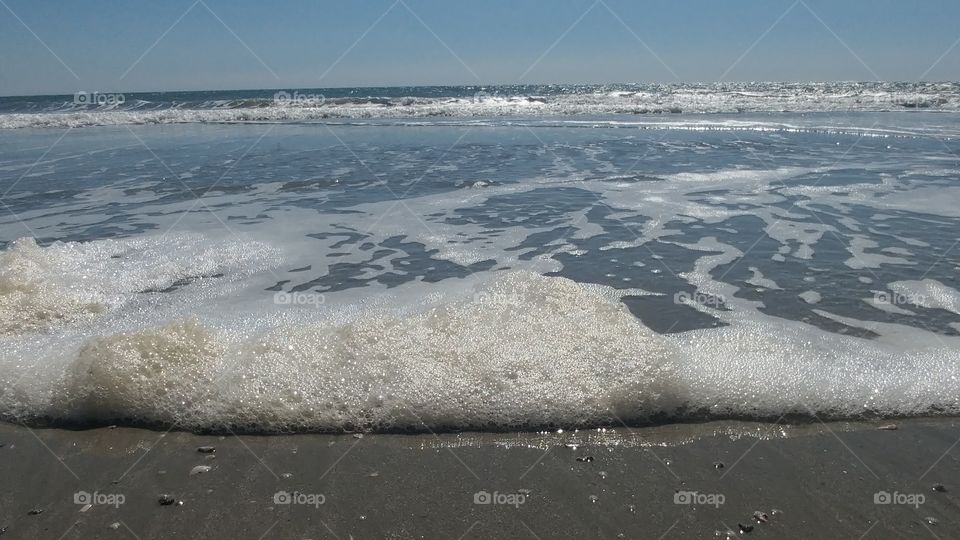 sea waves on beach with clear sky