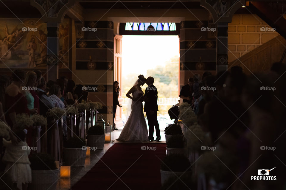 father kissing his daughter's forehead church entrance