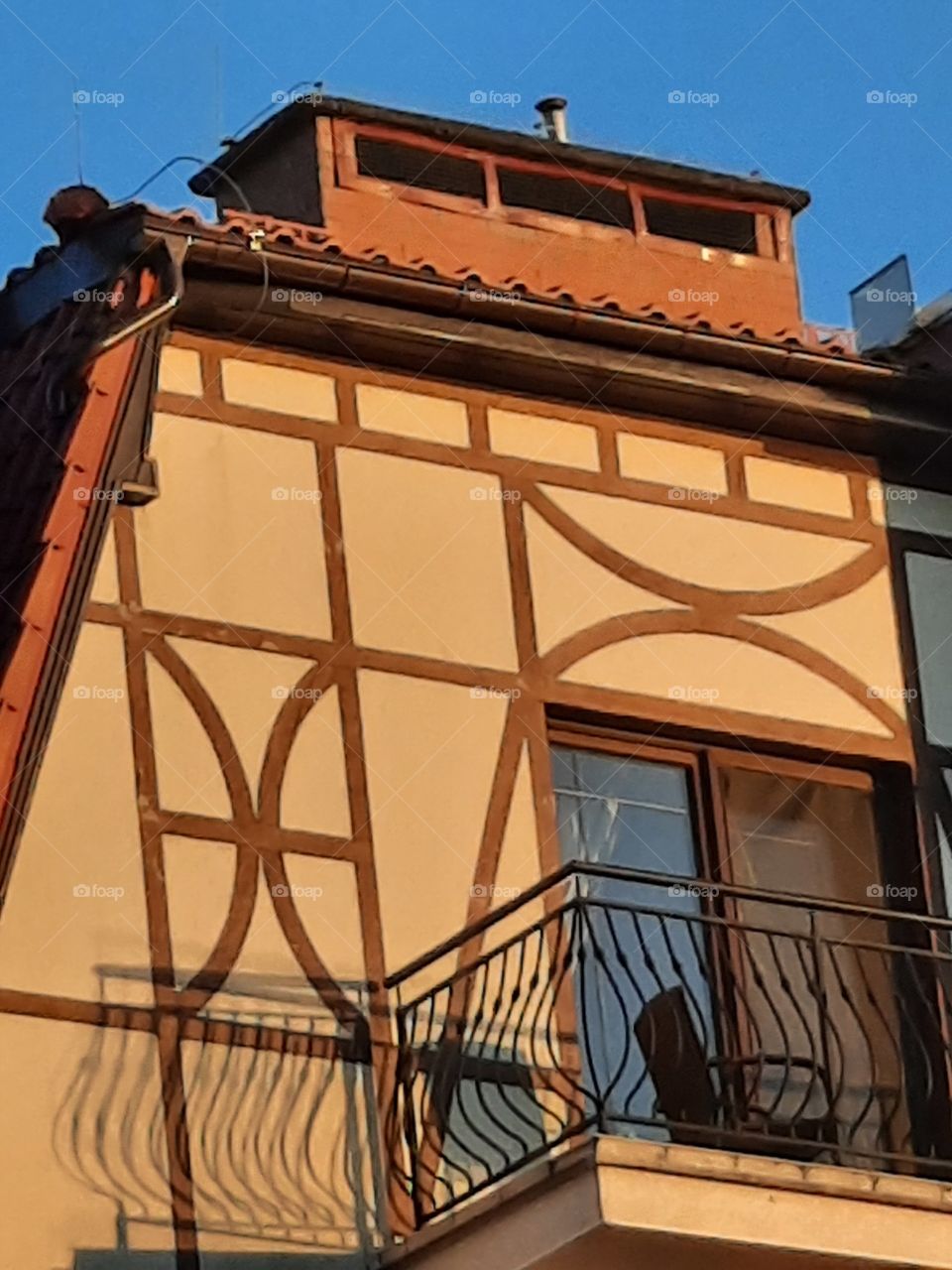 sharp shadows of balcony railing on the wall at golden hour