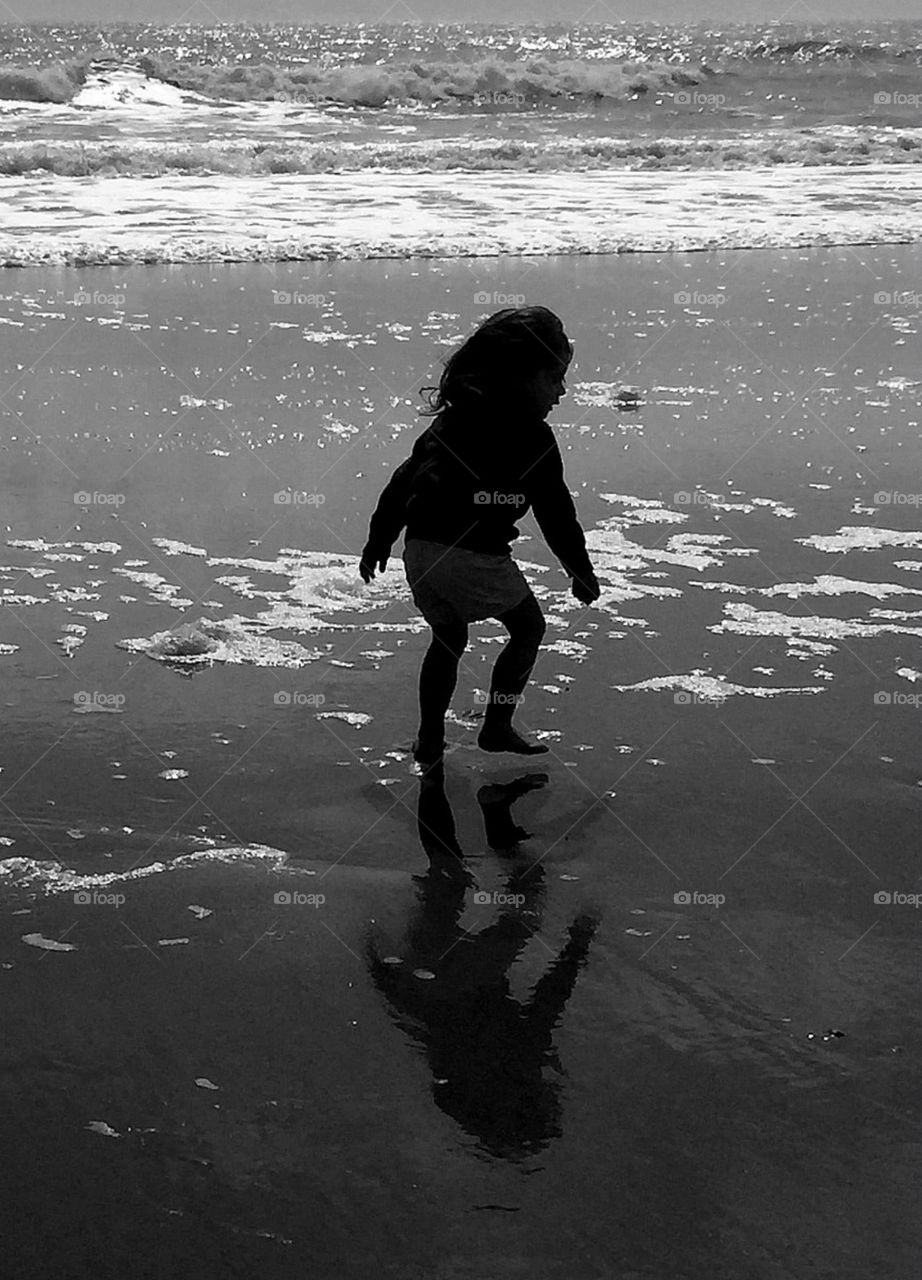 Sweet shadows. Sweet play on the beach, with child and light