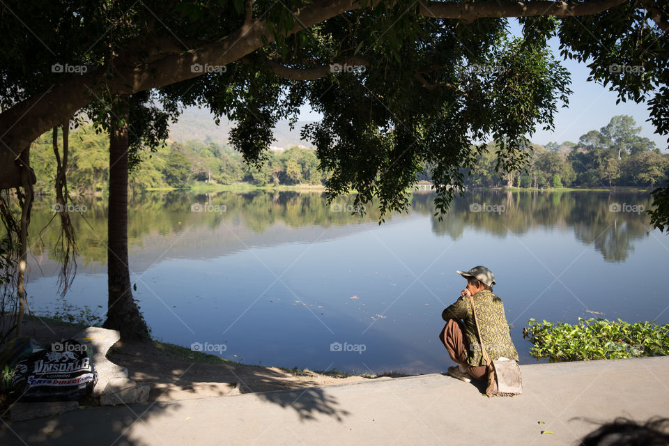 Woman sitting near the pond