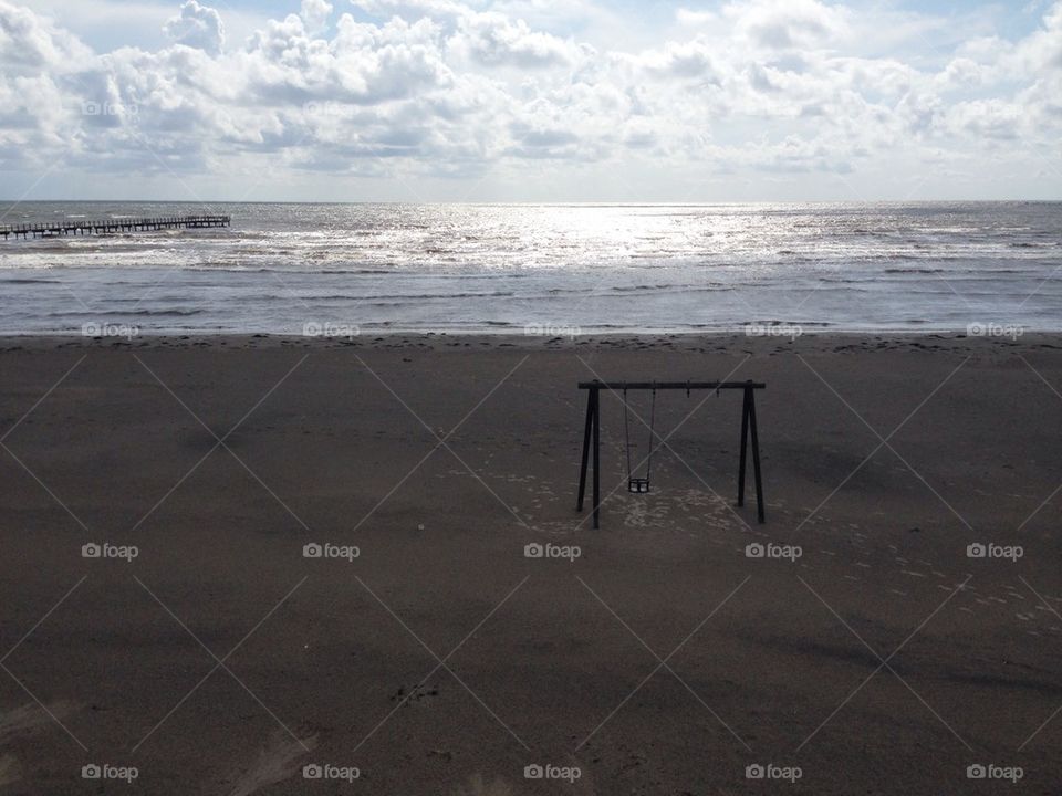 Swing near sandy beach