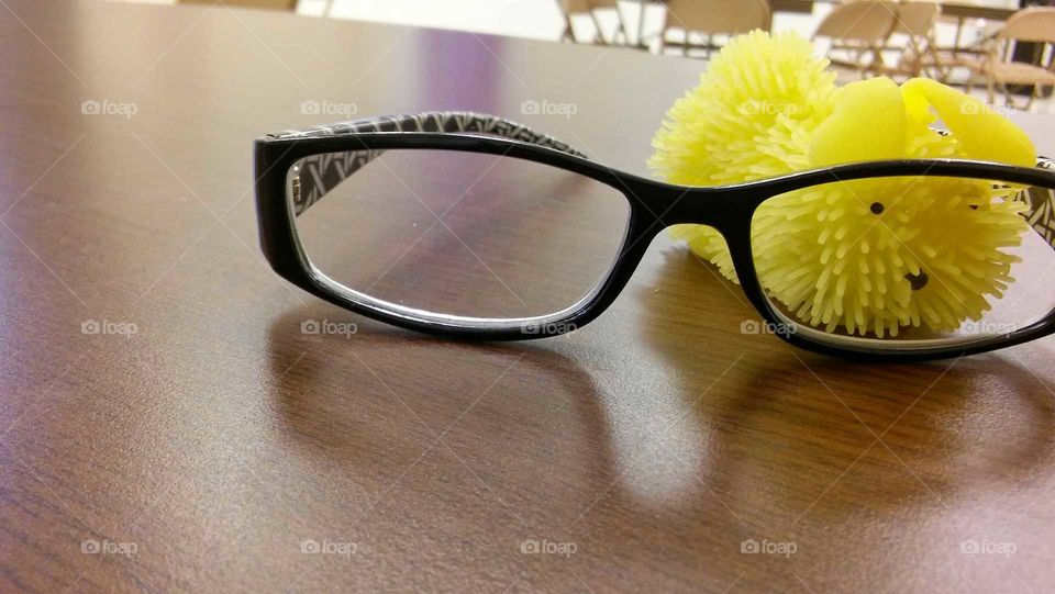 Glasses on table, yellow object