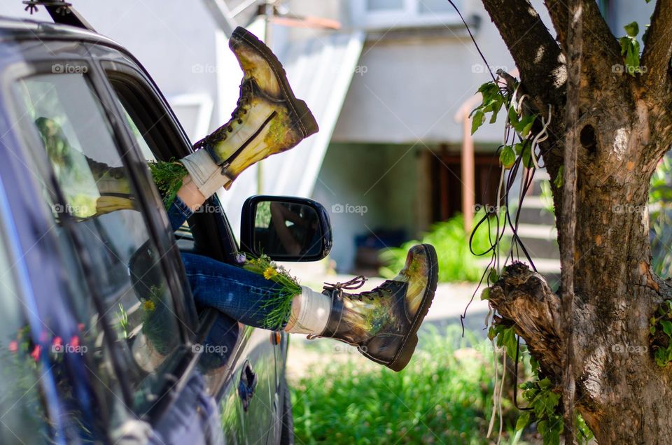 What's that doing here 😃? Woman Lying in Car With her Feet Out of Car Window. She Have Flowers Inside the Boots